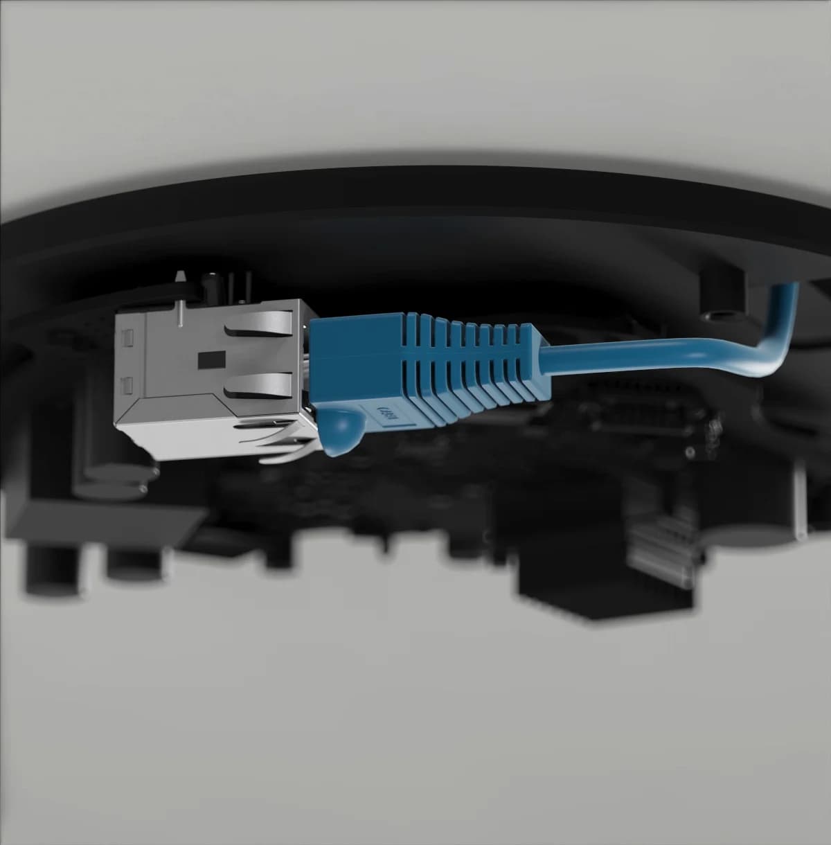 Closeup of a sensor's network port with an Ethernet cable plugging in